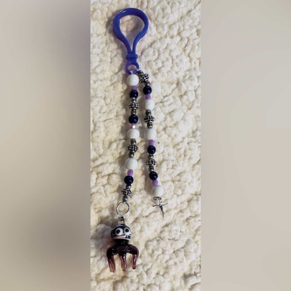 Handmade Glass octopus with metal cross keychain.